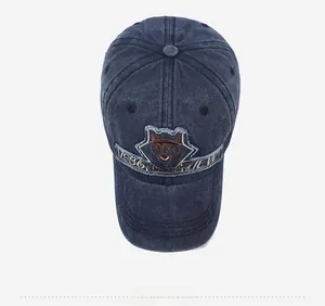 Top view of vintage washed navy denim baseball cap with detailed animal embroidery