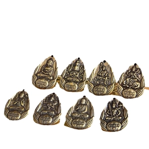 Set of seven copper-plated leaf-shaped Buddhist guardian amulets with detailed relief
