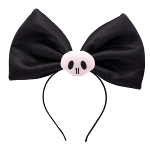 Detail of black satin bow headband featuring a pink plush skull for Halloween party style