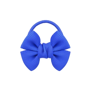 Detail shot of a blue fabric bow hair tie with premium texture on a white background