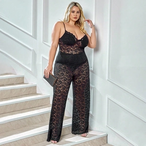 Close-up of intricate floral lace texture on a black plus size wide leg jumpsuit