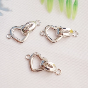 Detail of 14K gold plated double heart jewelry connectors for DIY necklaces