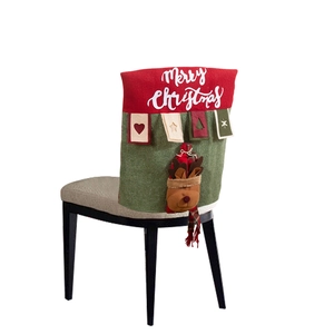 Close-up of a festive red and green Christmas chair cover with a 3D reindeer doll design