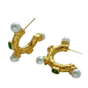 Golden C-shaped earrings with irregular texture, white pearls and green gemstones