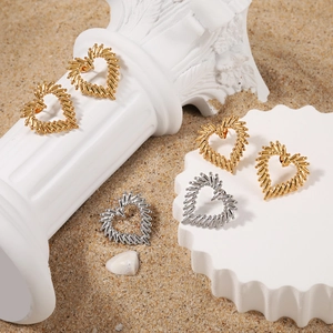 Minimalist gold and silver hollow heart stud earrings with unique textured metal beads