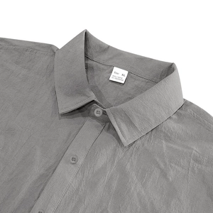 Detail of grey men's linen shirt collar with button and fabric texture in XL size