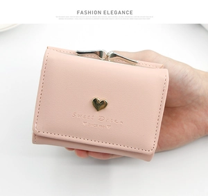 Close-up of pink PU leather tri-fold wallet with gold heart metal clasp and embossing