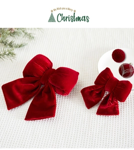 Detail of red velvet Christmas bows in large and small sizes with festive holiday decor