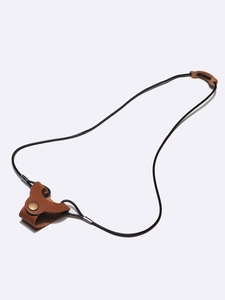 Detail view of brown faux leather glasses neck strap with brass snap button closure