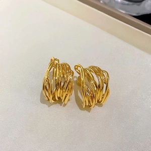 Modern gold irregular geometric C-shaped hoop earrings with woven metallic texture