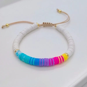 Close-up of bohemian colorful heishi beads and adjustable braided cord bracelet detail