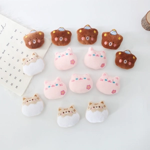 Detailed view of plush animal bear and cat brooches with exquisite embroidery details