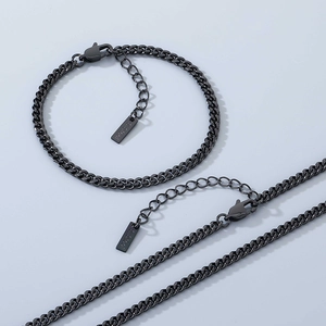 Detail of black stainless steel Cuban link necklace and bracelet set with lobster clasp