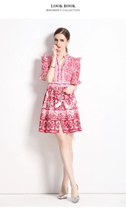 Detail of red and white Majolica print on V-neck buttoned dress with puff sleeves