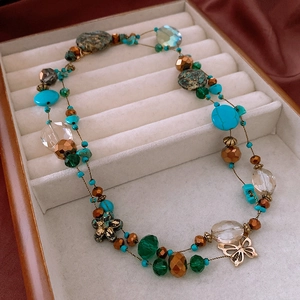 Detail showing bohemian turquoise beads and vintage metal flower and butterfly charms