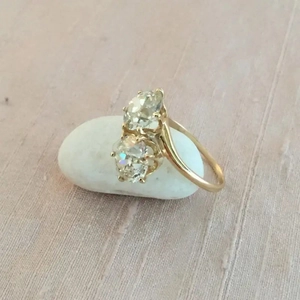Detail of two sparkling round diamonds in a classic 18K gold four-prong setting