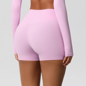 Detail view of high-waist light pink yoga shorts with elastic seamless peach lift design