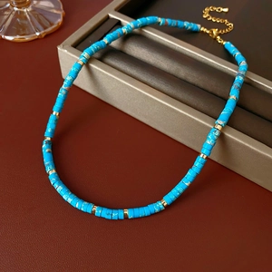 Detail of round Shoushan stone beaded necklace with gold spacers and lobster clasp