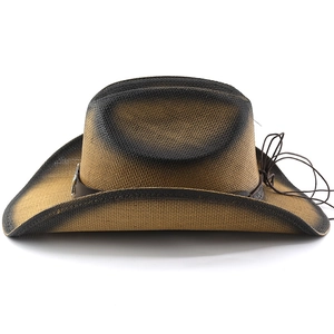 Detail of western straw cowboy hat featuring leather band and silver star emblem