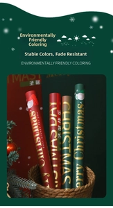 Detail of festive gold-stamped Christmas wrapping paper in a basket with holiday decor