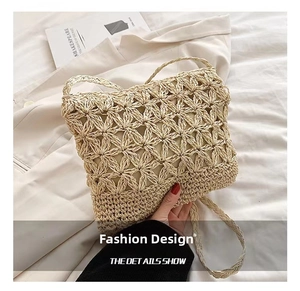 Detailed close-up of handmade hollow flower straw crossbody bag for summer beach vacations