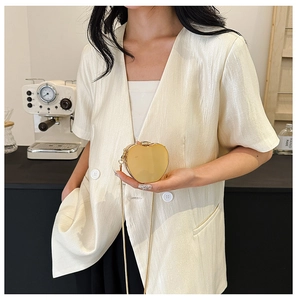 Golden heart-shaped acrylic dinner bag with a metallic finish and elegant chain strap