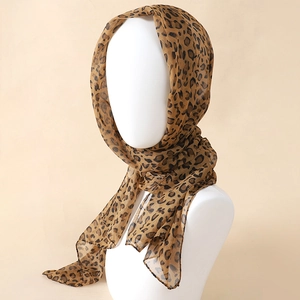 Close-up of leopard print chiffon scarf tied as a headband on mannequin