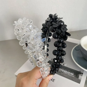 Detail of beaded flower headbands in black and clear colors with elegant crystal pearls