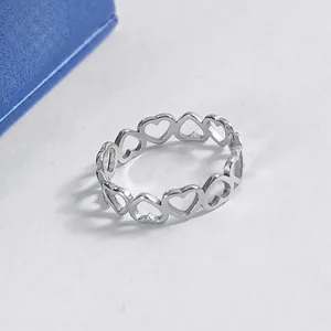 Polished silver stainless steel openwork heart ring with a minimalist aesthetic design