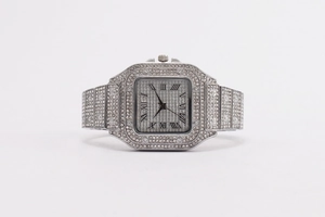 Macro view of square silver watch with full rhinestone inlay and Roman numeral dial