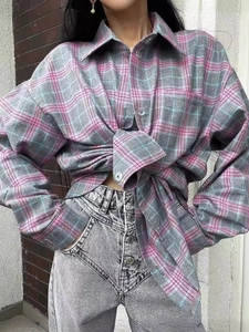 Pink and grey oversized plaid shirt paired with high waist acid wash jeans streetwear look