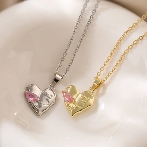 Elegant gold and silver heart necklaces featuring pink teardrop gemstones on ceramic