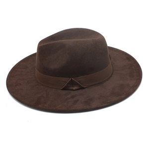 Detail of dark brown faux suede cowboy hat showing wide brim and ribbon band