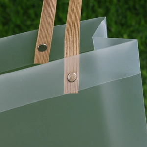 Frosted translucent PP gift bag featuring durable paper handles and metal rivet reinforcement