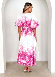 Back view of a white floral midi dress with puff sleeves and smocked waist detail