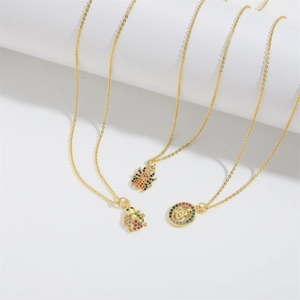 Gold necklaces featuring colorful zircon ladybug, spider, and snake disc pendants