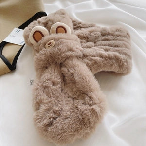 Detail of soft plush light brown scarf featuring cute bear design on white fabric