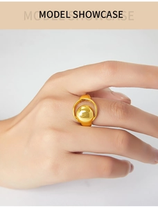 Model wearing a minimalist gold-plated geometric ring with a hollow moon design