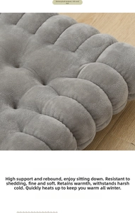 Close-up of thick dark grey plush cushion showing soft texture and stitched pattern