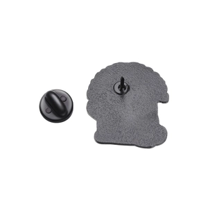 Detail of the back of a black metal cat brooch showing texture and rubber pin clutch