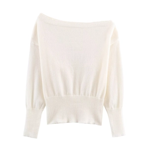 Detail of white off-the-shoulder knit sweater with ribbed cuffs and refined texture