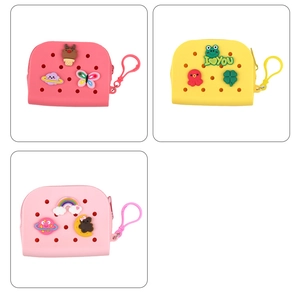 Detailed view of pink and yellow silicone coin purses with various cartoon charms and zippers