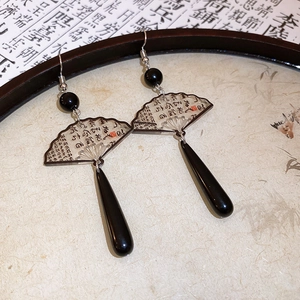 Detail of vintage Chinese style fan earrings with ink calligraphy and teardrop resin