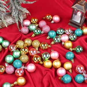Assorted Christmas ball ornaments in matte and glitter finishes on red satin background