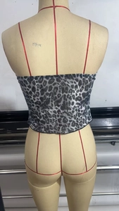 Detail of leopard print crop top featuring black and white animal pattern with elastic hem