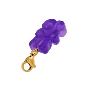 Detail of purple gummy bear pendant with golden lobster clasp on a white background