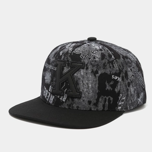 Detail of black snapback hat with 3D letter K embroidery and graffiti rebel print