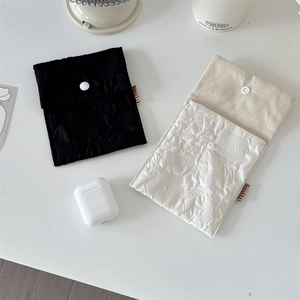 Quilted floral sanitary napkin pouch with envelope flap and button closure detail