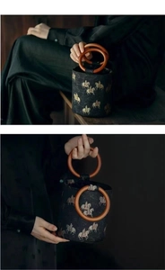 Macro detail of Chinese vintage bucket bag with Tang horse embroidery and wooden handle