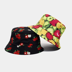 Close-up of cotton canvas bucket hats with vibrant apple patterns and detailed stitching